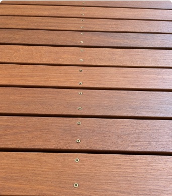 Neatly aligned stainless screws on deck board